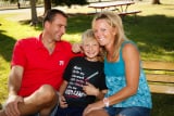 Family sitting in central park at Lakeside Amusement Park in Denver, Colorado